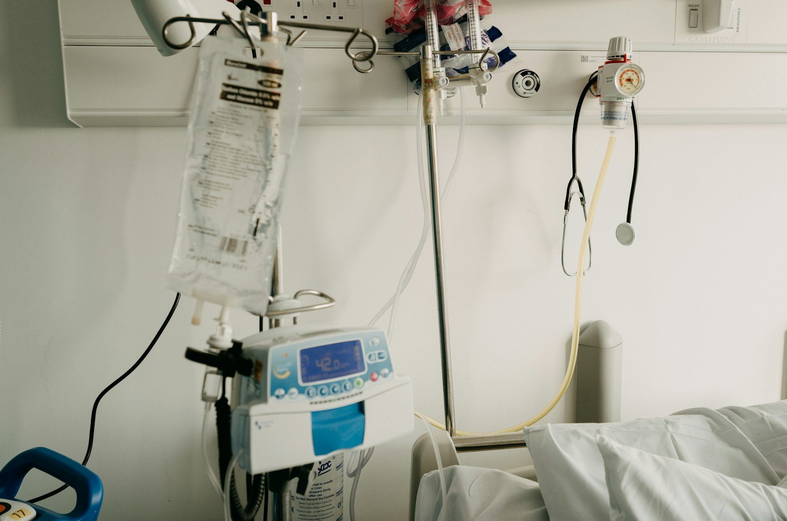 Empty hospital room with bed and medical equipment